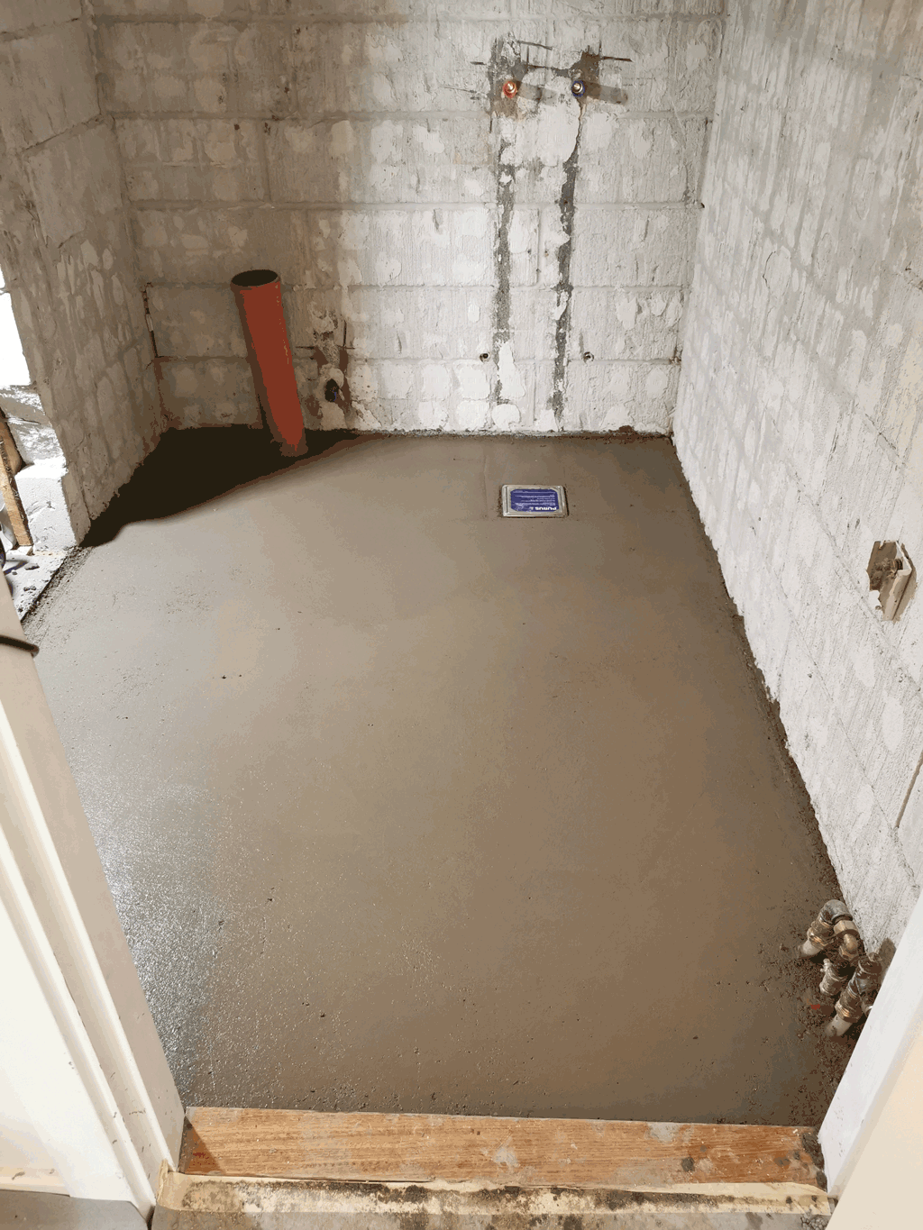 Badeværelsesrenovering. Badeværelset har fået støbt nyt beton gulvpå billedet ses det øverst lag beton som hedder slidlag.